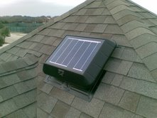 Solar attic fan on a roof cooling an attic and a home